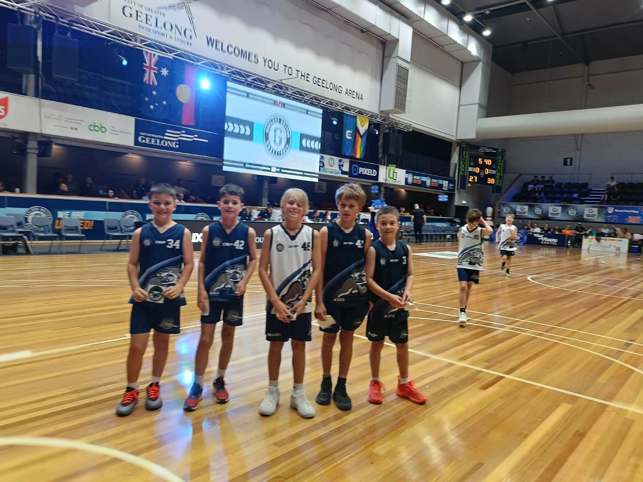 Young Bobcats players in uniform on the court at Geelong Arena